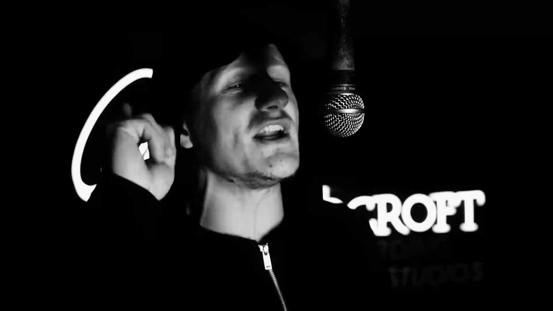 Artist MC Innes recording vocals into a studio microphone at Moorcroft Studios